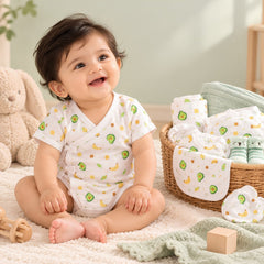 Mom's Home newborn hospital kit with 20 organic cotton baby essentials in avocado print, displayed in a nursery